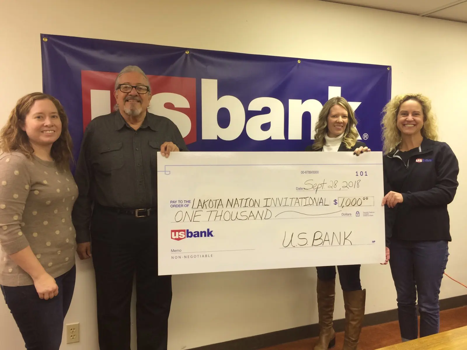 Giant check being presented to Lakota Nation Invitational