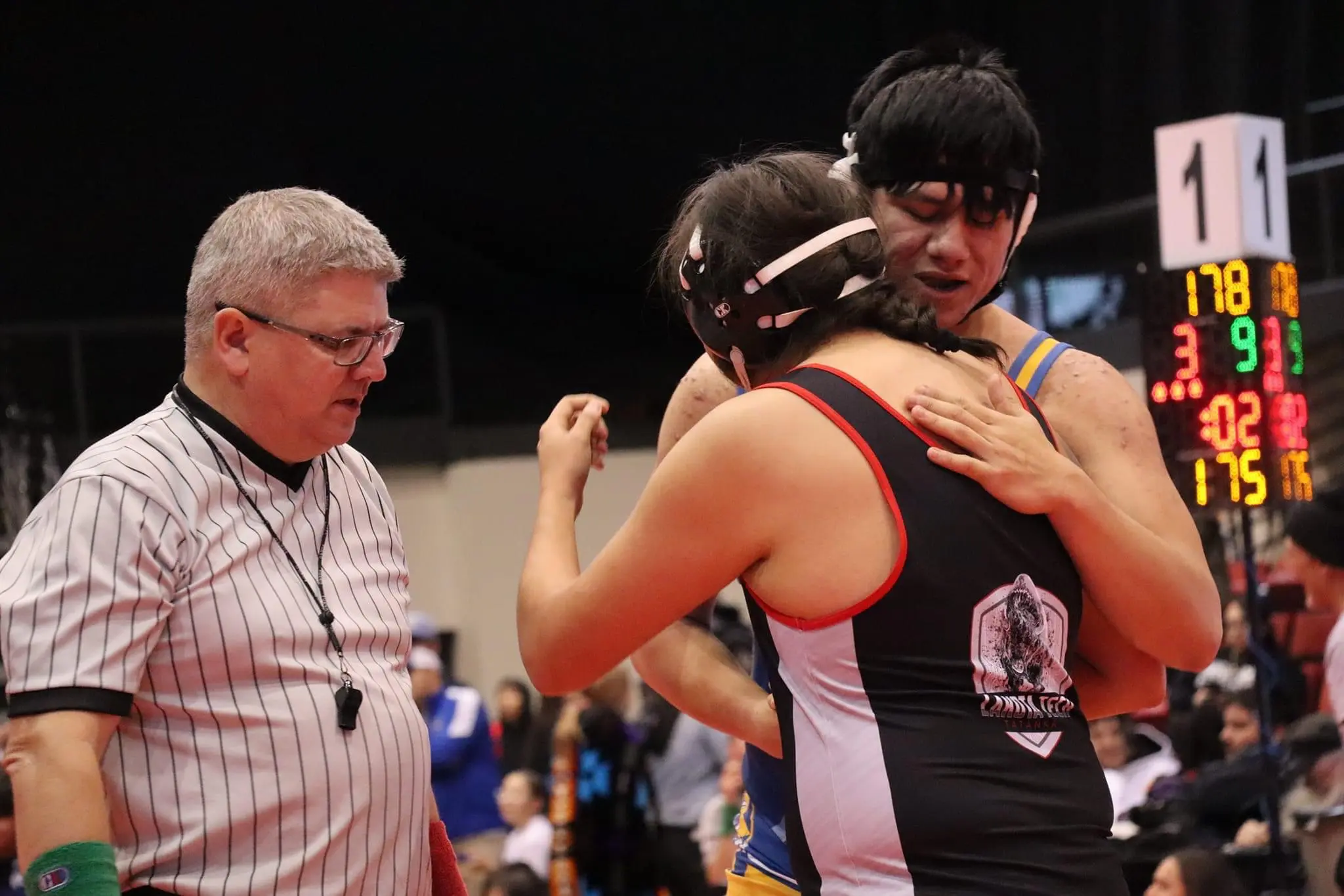 Wrestlers embracing in good sportsmanship